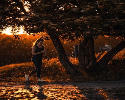 man jogging in the park during sunrise